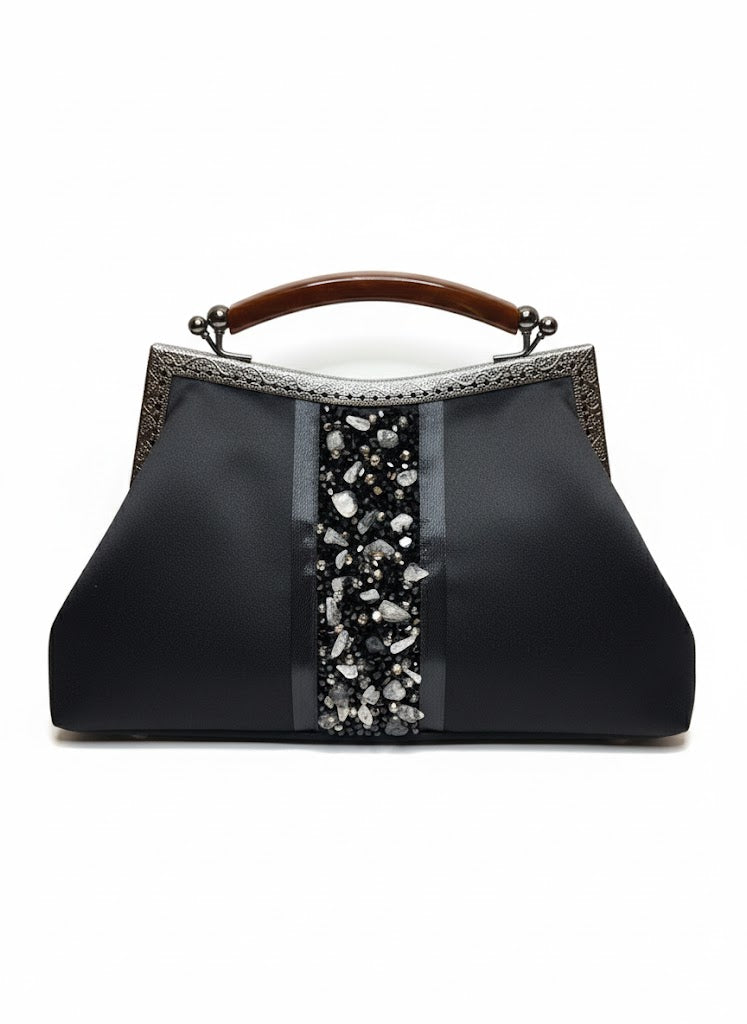 Elegant black handbag with wooden handle and decorative stone embellishments
