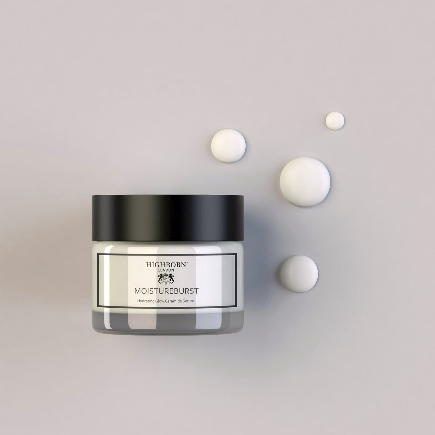 Highborn London MoistureBurst Hydrating Glow Ceramide Serum jar with black lid and cream droplets