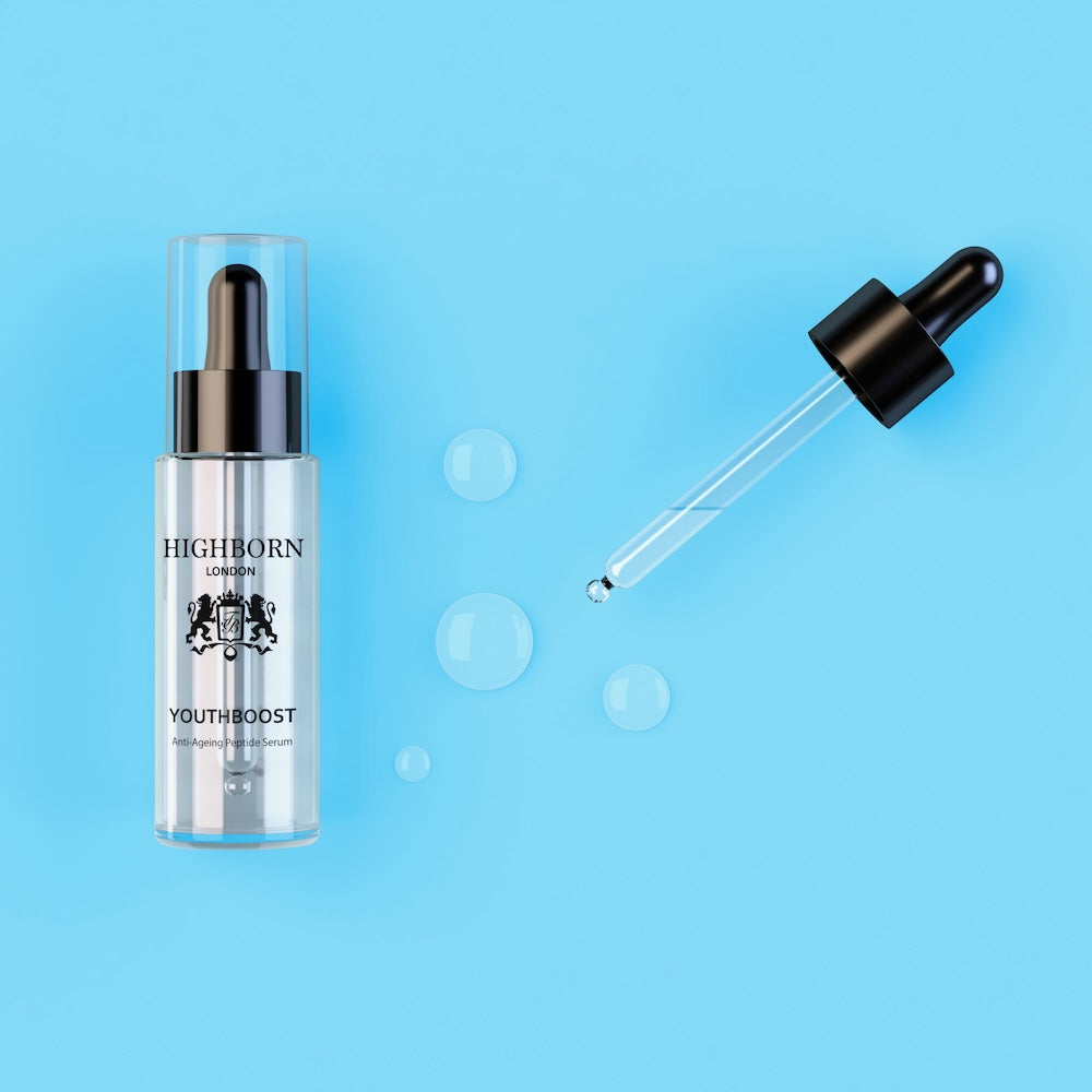 Highborn London Youthboost anti-ageing peptide serum bottle and dropper on blue background with water droplets
